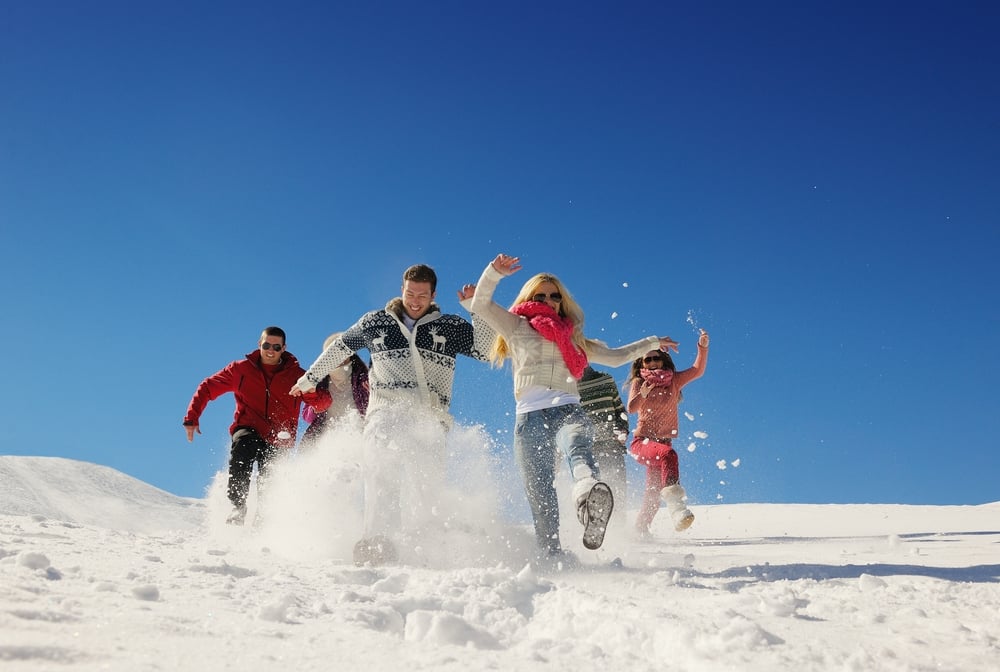 happy friends group  have fun at winter on fresh snow, healthy young people outdoor